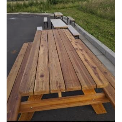 Wooden picnic table sitting outside